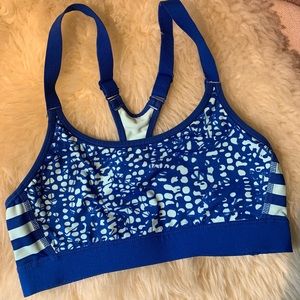 Blue polka-dot and striped sports bra with adjustable straps.